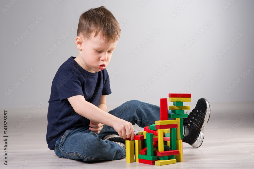 Boy playing with wooden cubes Boy playing with wooden cubes