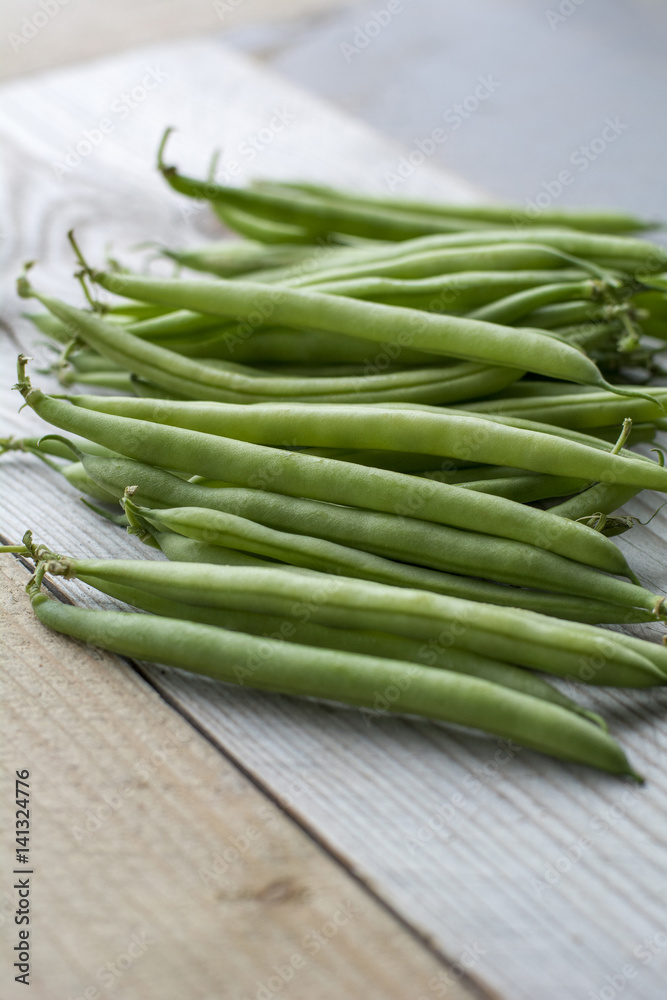 Bunch of fresh green beans on the wooden background Bunch of fresh green beans on the wooden background