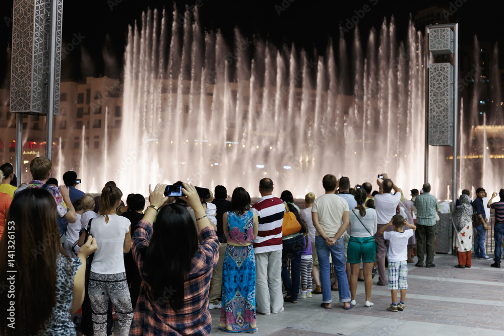 Obraz premium Night view fountains downtown and in a man-made lake, Dubai UAE