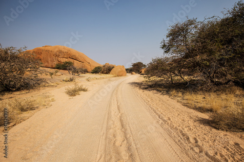 Street in the Namibian savannah with blue sky