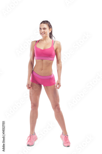 Woman fitness model posing in front of camera and showing her muscles. Isolated white background © Виталий Сова