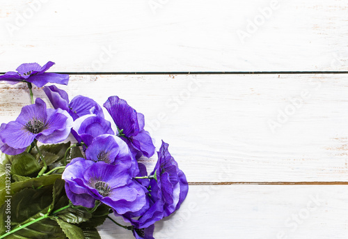 Violet flowers on wooden background