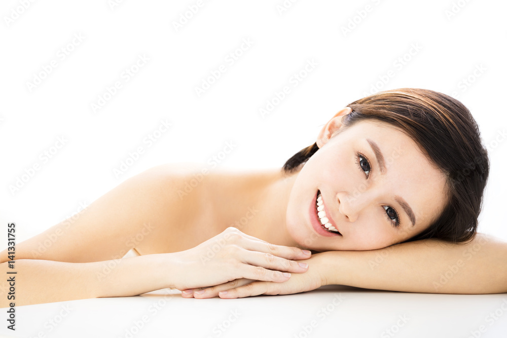 Beautiful woman lying down on towel during skin care treatment Beautiful woman lying down on towel during skin care treatment