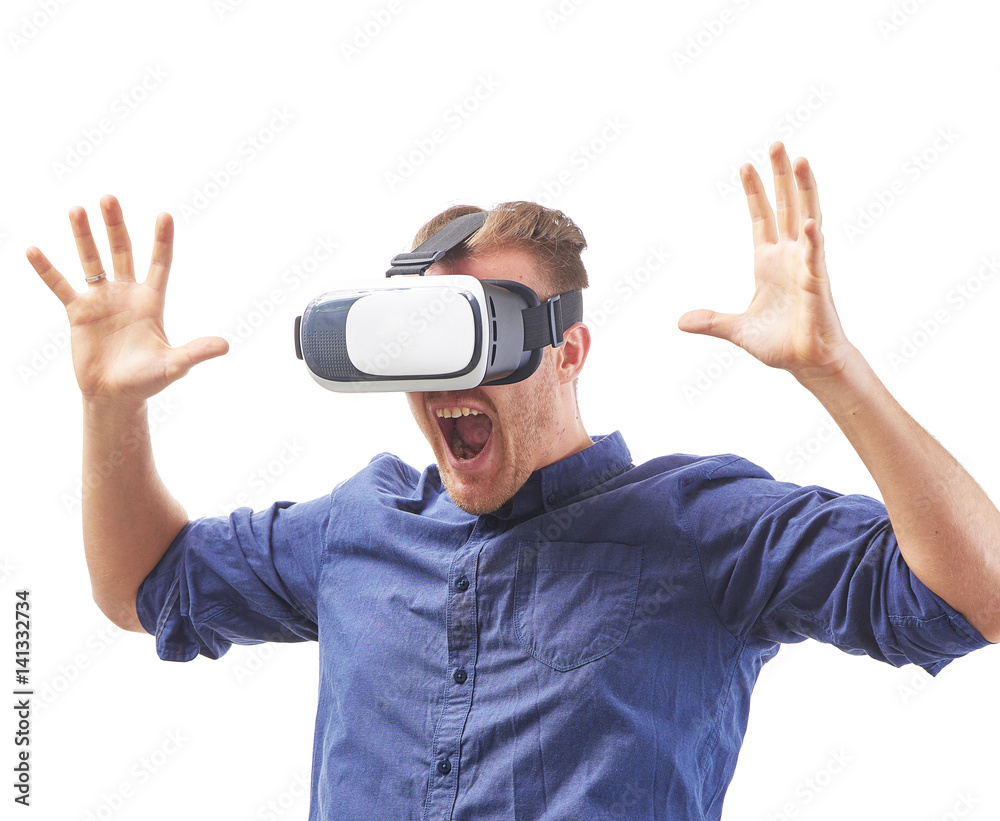 Screaming young man using a VR headset enjoying interactive game with fear emotion and experiencing virtual reality isolated on white background Screaming young man using a VR headset enjoying interactive game with fear emotion and experiencing virtual reality isolated on white background