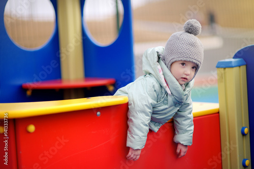  Cute little toddler walks at the playground outdoors in spring