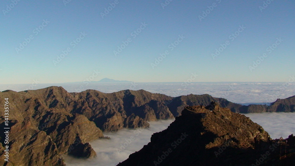 The mountain peaks rise above the clouds array, Canary Islands.
