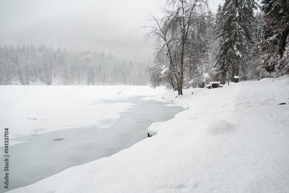 Obraz premium On the frozen lake during a snowfall. Fusine, Udine