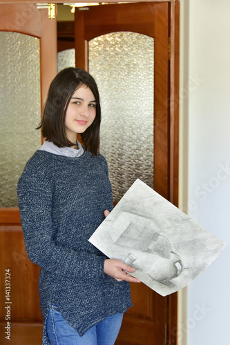 Drawing girl / Photo-portrait of teenage girl with raw draft in hands