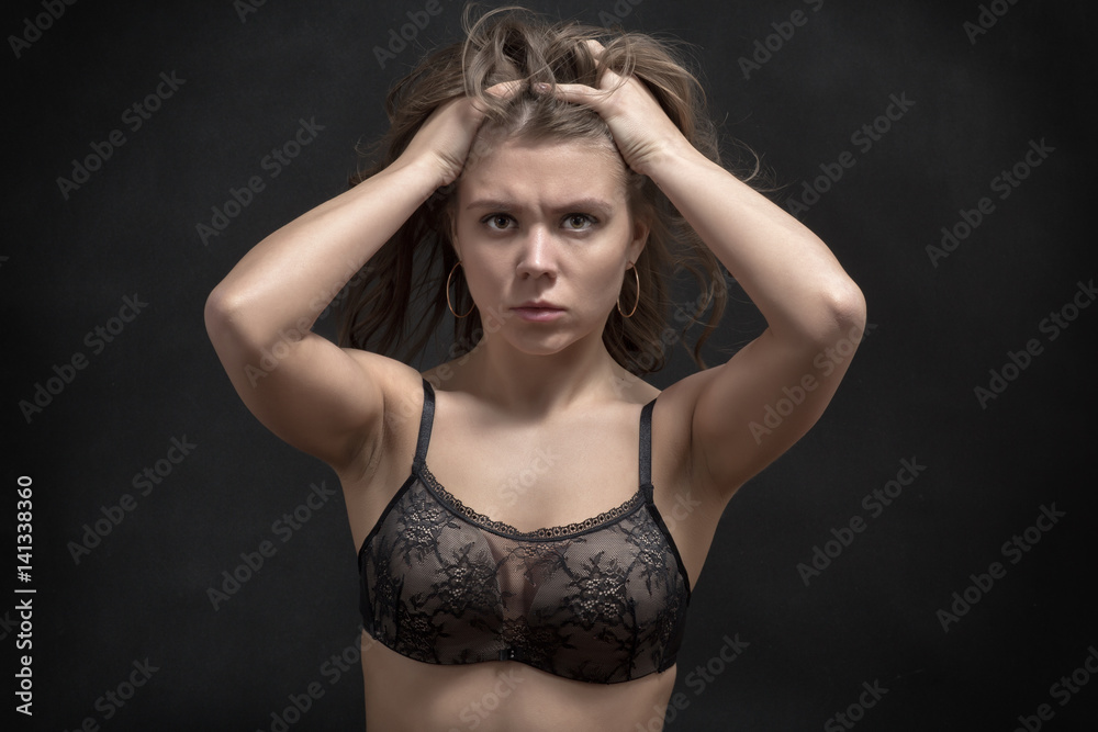 serious sad girl portrait on black background