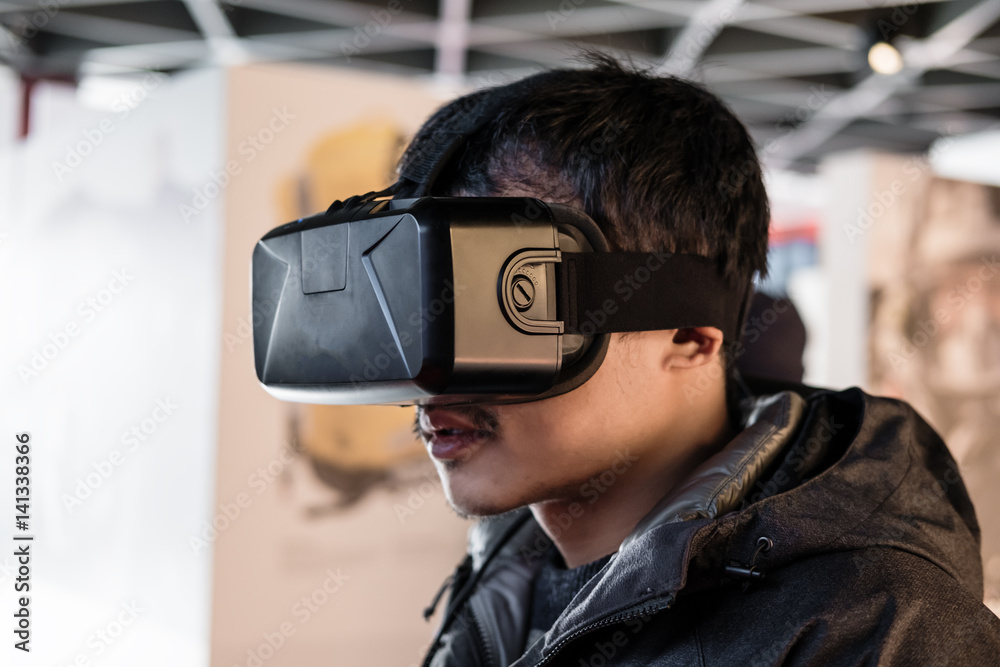 Fototapeta premium a man wearing VR virtual reality goggles