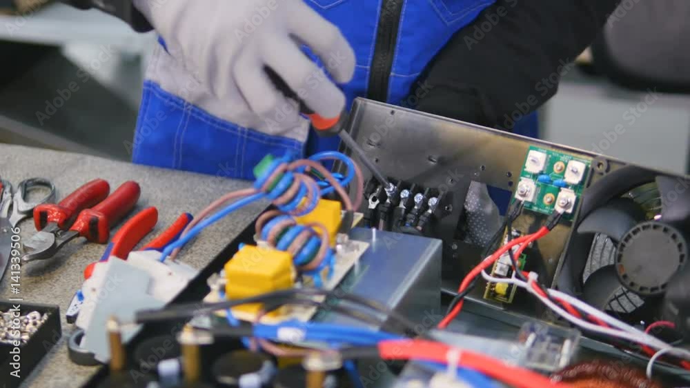 Electrician assembles equipment into electrical control cabinet, fuse box. 4K. Electrician assembles equipment into electrical control cabinet, fuse box. 4K.
