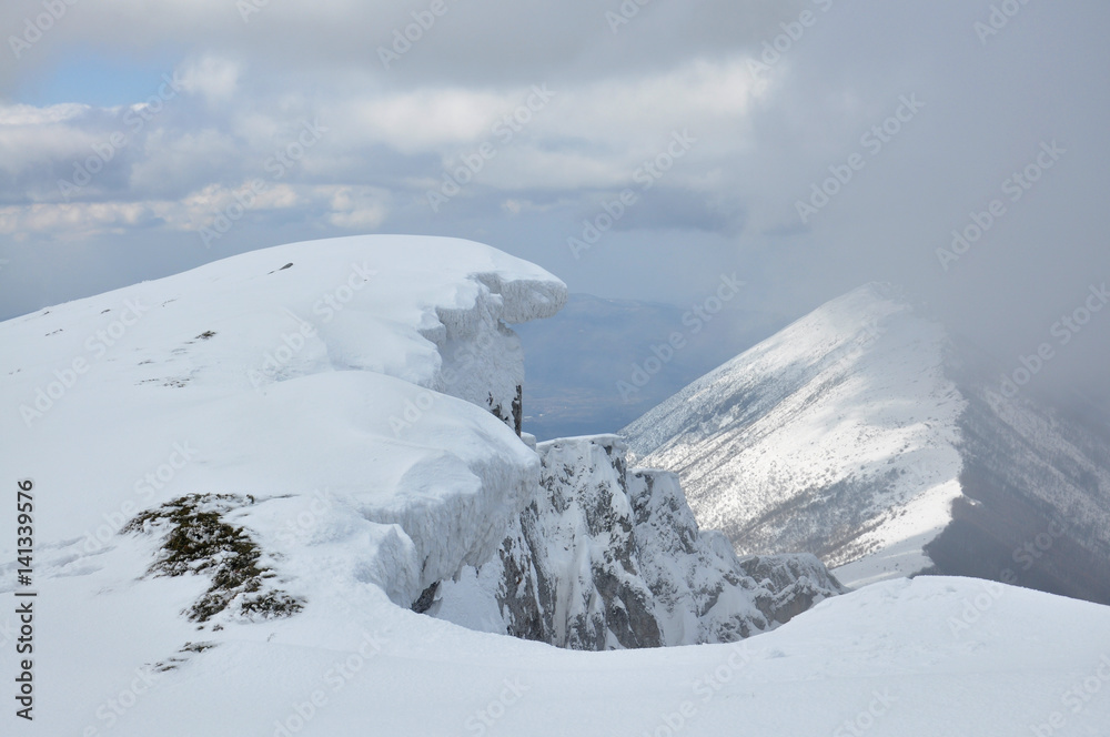 Snowy  eaves on the edge of the cliff on top of the mountain. Mountain peak Trem, Dry mountain, Serbia