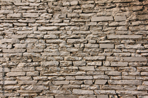 Natural grunge brown stone wall background and texture.