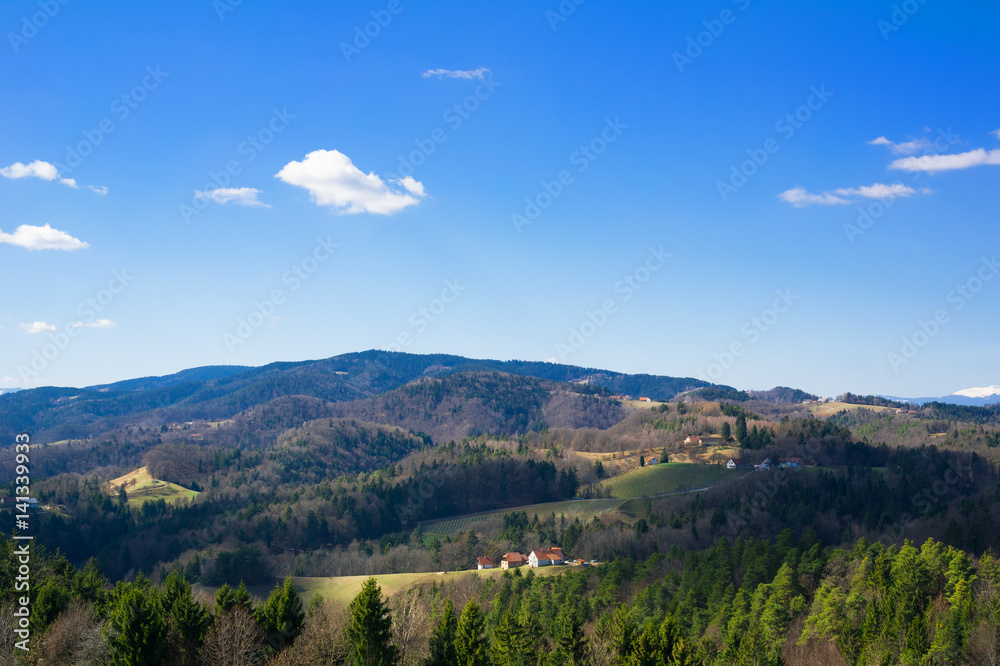 Kozjak mountain range, vicinity of Maribor, Slovenia, Europe - beautiful natural scenery of slovenian countryside. Landscape with forests, hills, mountains, meadows, farms and houses.