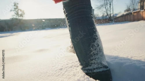 Girl feet walks in the snow