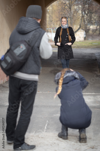 Photographers work with a model on the street