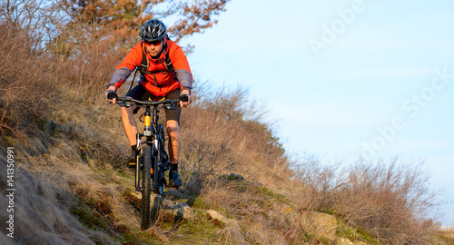 Enduro Cyclist Riding the Mountain Bike on the Rocky Trail. Extreme Sport Concept. Space for Text. © Maksym Protsenko