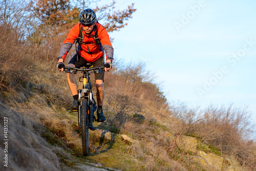 Enduro Cyclist Riding the Mountain Bike on the Rocky Trail. Extreme Sport Concept. Space for Text. © Maksym Protsenko
