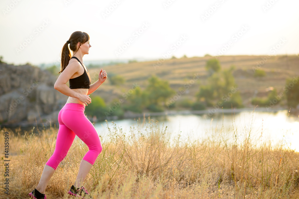 Young Woman Running on the Morning Trail. Active Lifestyle Concept. Young Woman Running on the Morning Trail. Active Lifestyle Concept.