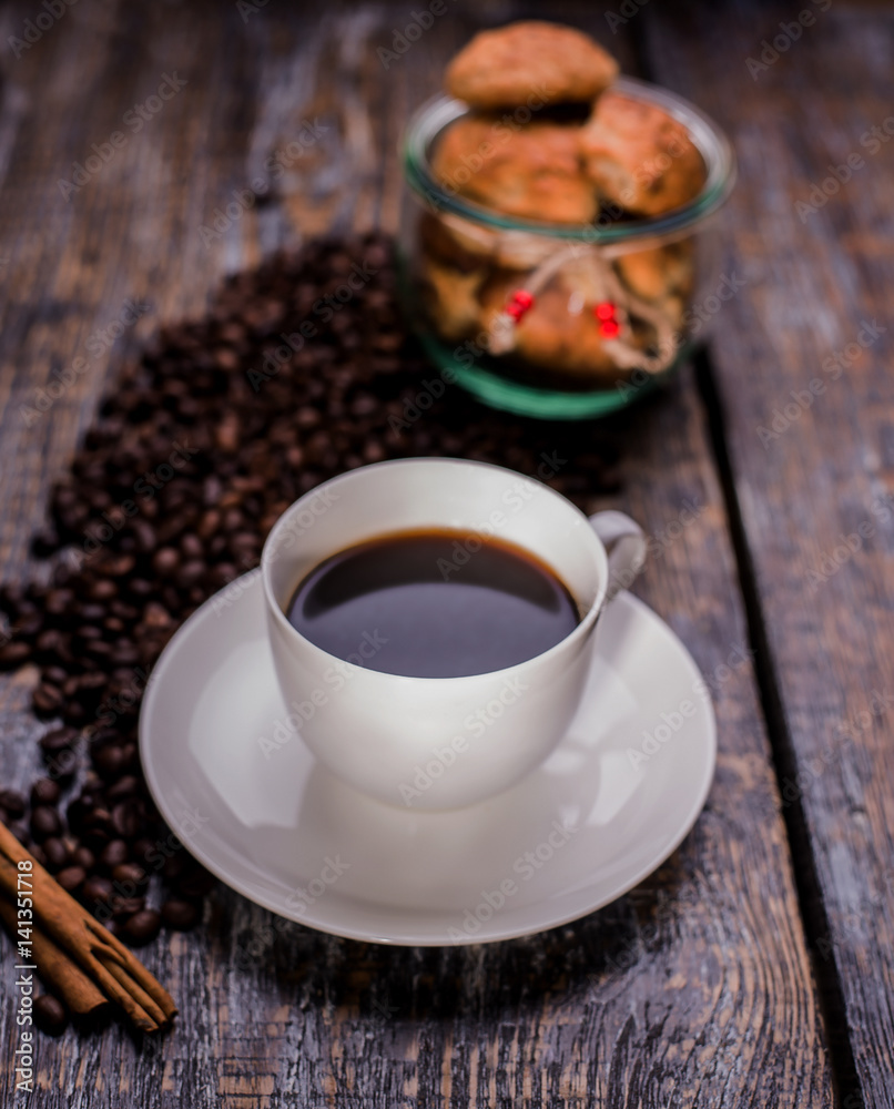 Coffee cup, coffee beans and biscuits, cookies in the shape of heart on wooden background Coffee cup, coffee beans and biscuits, cookies in the shape of heart on wooden background