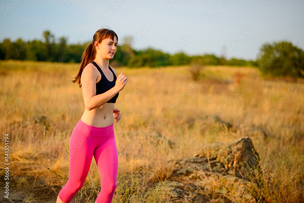 Young Woman Running on the Morning Trail. Active Lifestyle Concept. Young Woman Running on the Morning Trail. Active Lifestyle Concept.