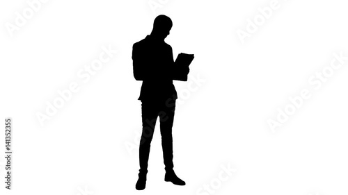 Silhouette Young businessman attentively studying documents