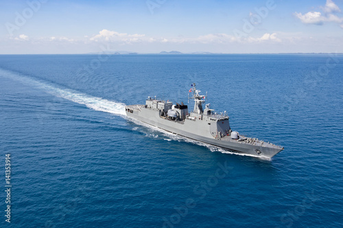 Grey modern warship, helicopter view photo