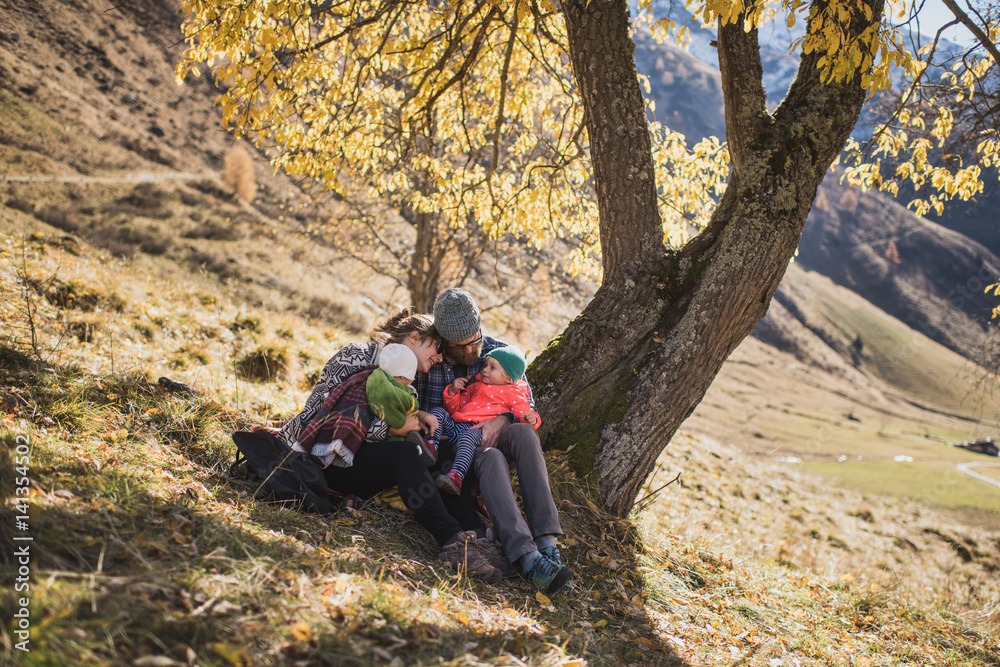 Family relaxing together under the tree Family relaxing together under the tree