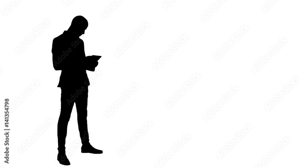 Silhouette Young businessman using digital tablet Silhouette Young businessman using digital tablet