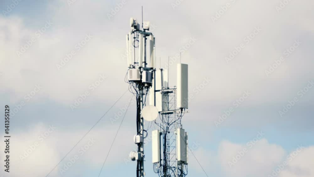 Technology on the top of the telecommunication tower (antenna, transmitter), blue sky, white clouds. Technology on the top of the telecommunication tower (antenna, transmitter), blue sky, white clouds.
