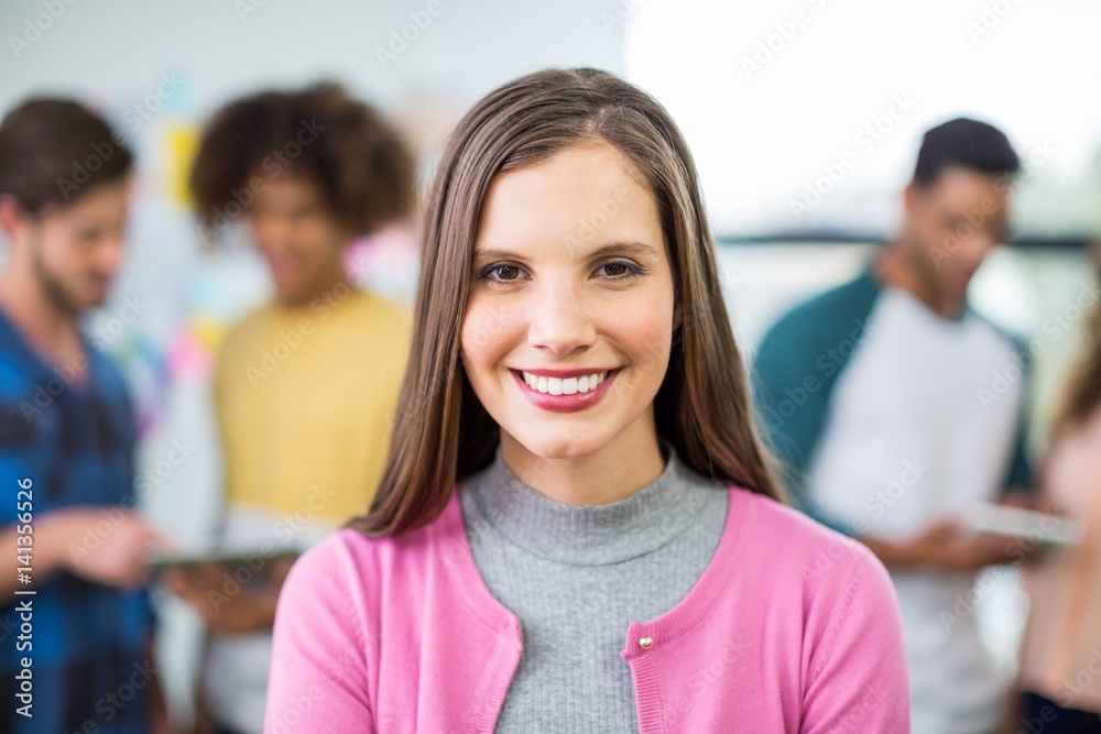 Happy female executive standing in office