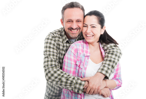 Cheerful young couple embracing and smiling