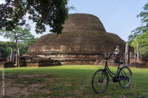 Bike in front of Pablo Vihara dagoba, Polonnaruwa, Sri Lanka photo