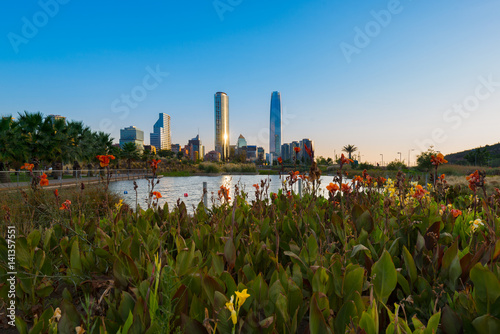 Pond at Bicentennial Park in the wealthy Vitacura district and skyline of buildings at financial district, Santiago de Chile photo