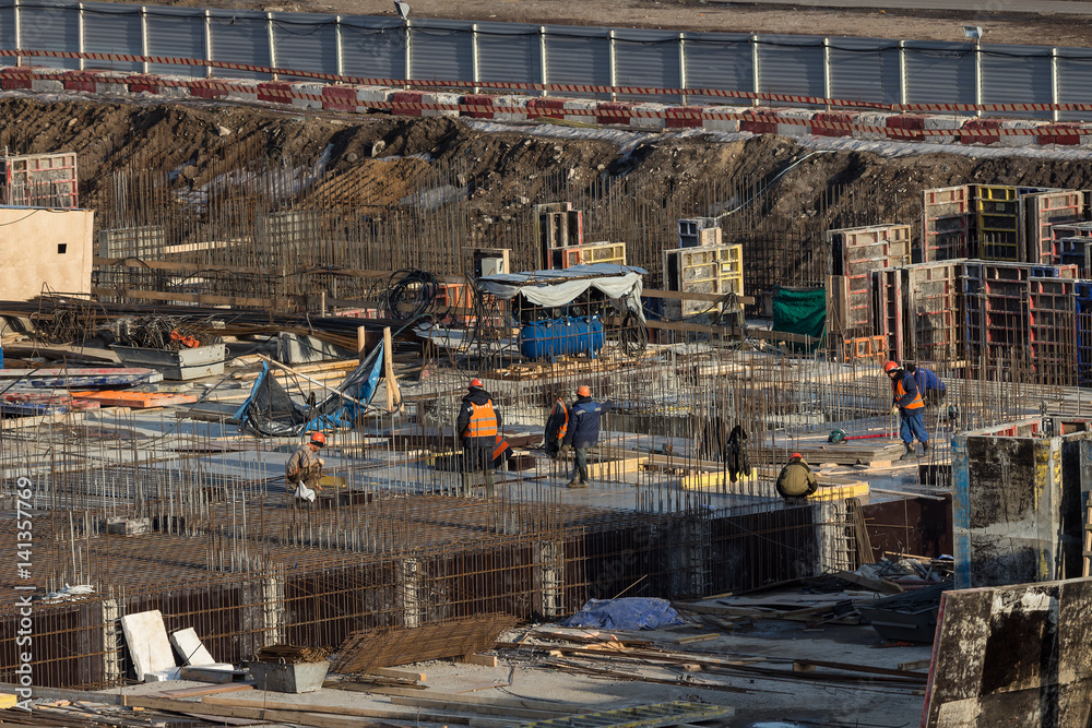 Workers on construction site. Pile foundation of building under construction