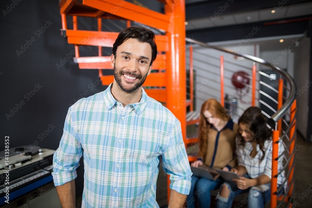 Smiling male executive standing in office