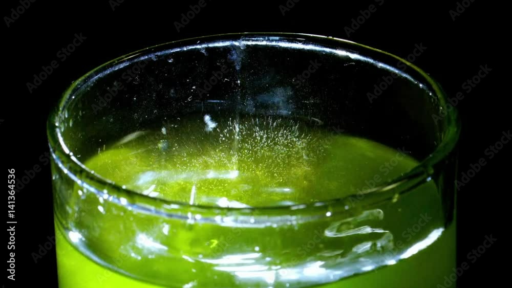 green cocktail in a glass on black background green cocktail in a glass on black background
