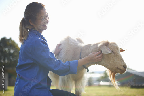 Woman patting goat photo