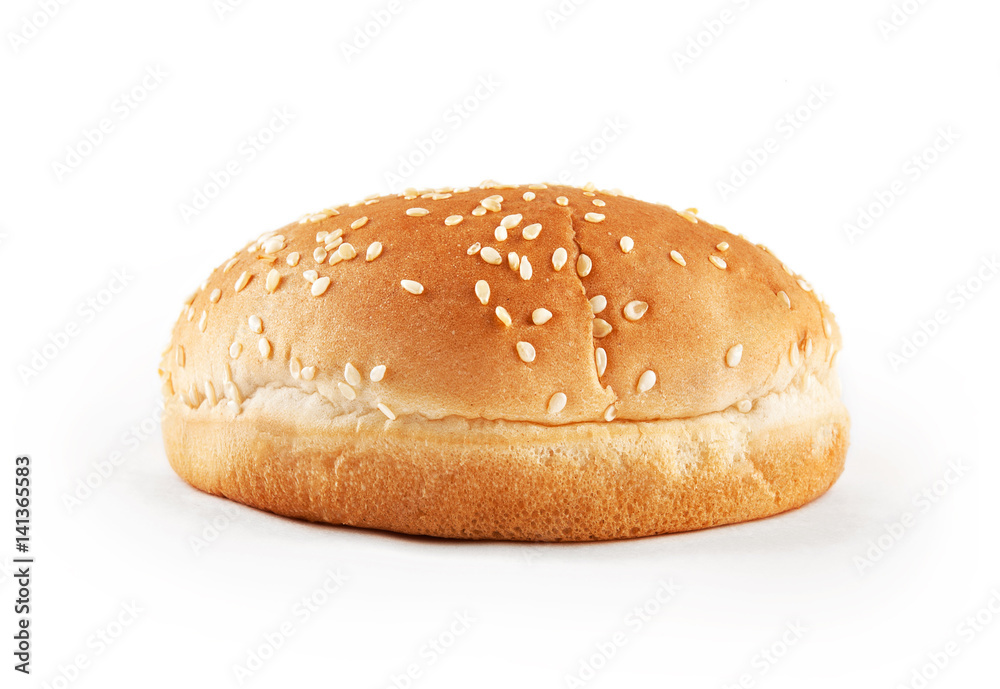Hamburger bun with sesame seeds isolated on white background. Front view.