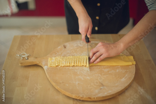 womans hands making tagliatelle
