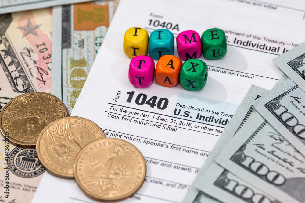 tax form with wooden cubes, dollar bills, coin. tax form with wooden cubes, dollar bills, coin.