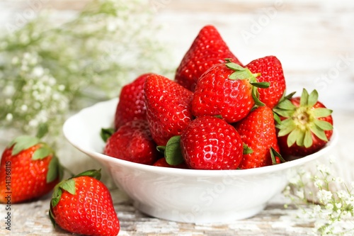 Still life of fresh strawberries on distressed white wooden background, selective focus
