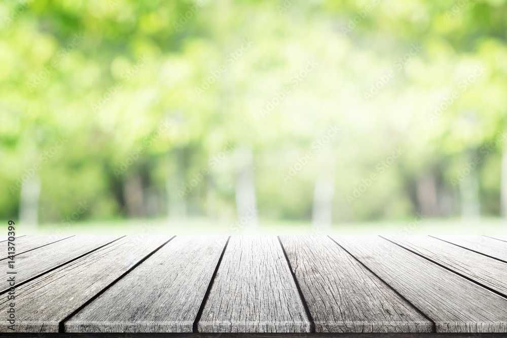 Empty wooden table with party in garden background blurred.