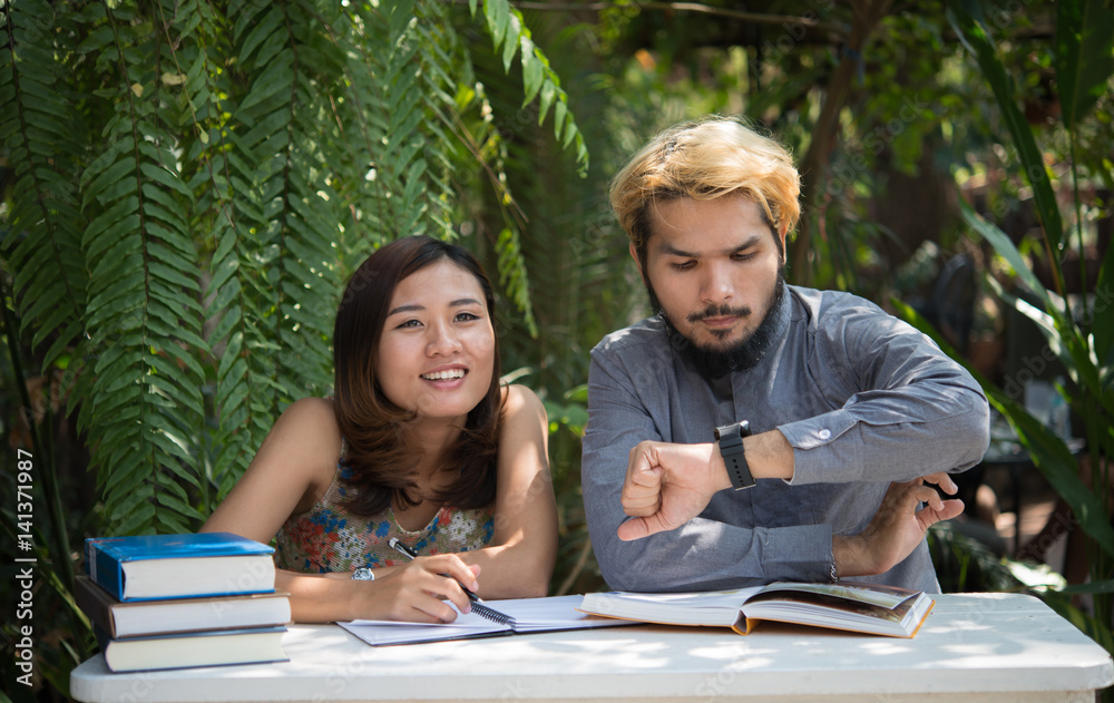 Young couple relaxing at home garden together. Young couple relaxing at home garden together.