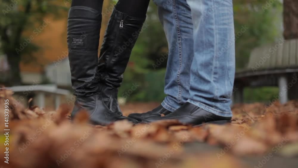 a loving couples feet on autumn leaves a loving couples feet on autumn leaves