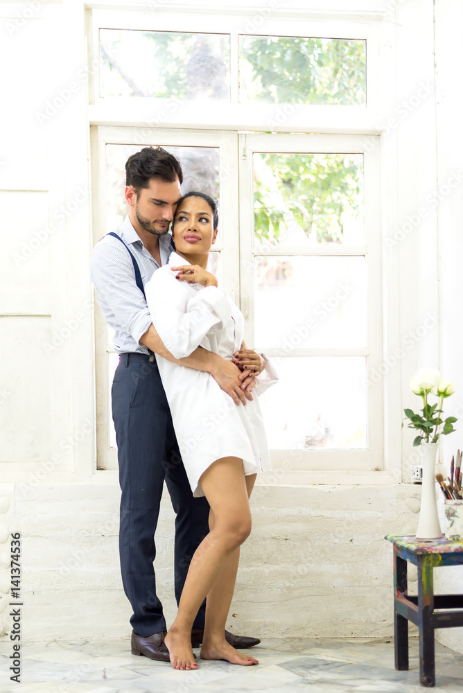 Happiness and romantic scene of love asian couples partners making eye contact in the white room.. Happiness and romantic scene of love asian couples partners making eye contact in the white room..