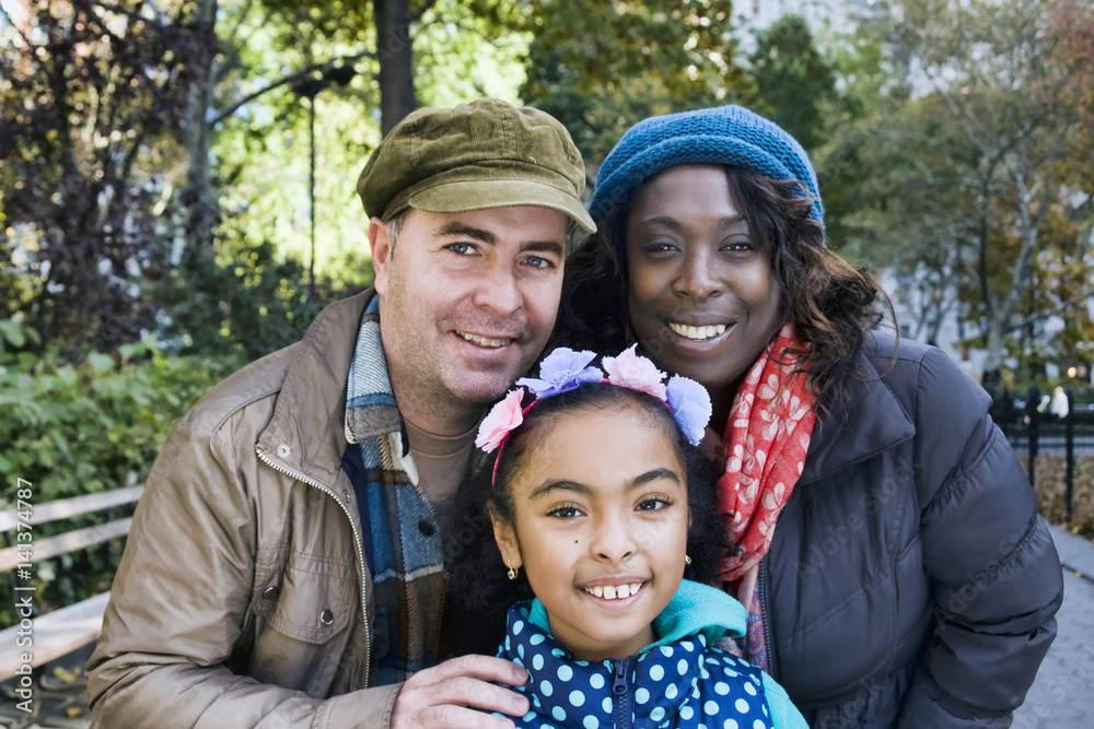Family in park looking at camera smiling Family in park looking at camera smiling