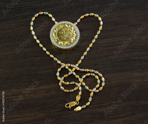 Ganesh spell necklace for good luck on wooden table / Selective focus