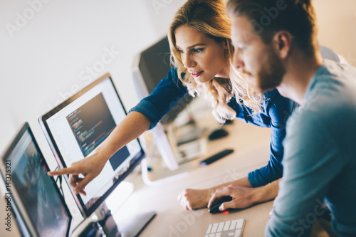 Programmer working in a software developing company photo
