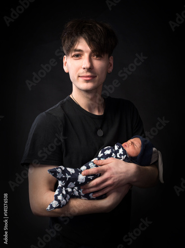 Young father and his newborn baby boy